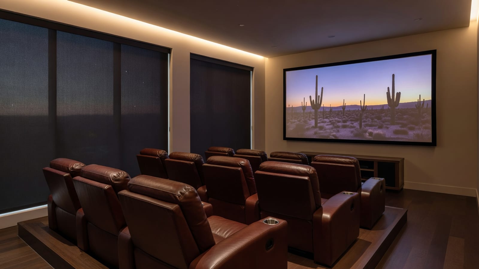 Home theater with blackout shades controlling light.